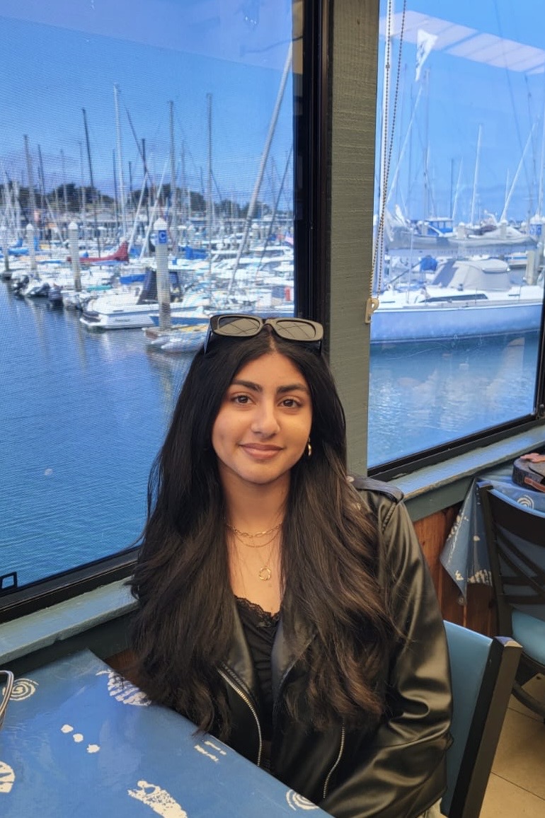 Manya Patel, founder of Wonder4Youth, sitting by a marina window